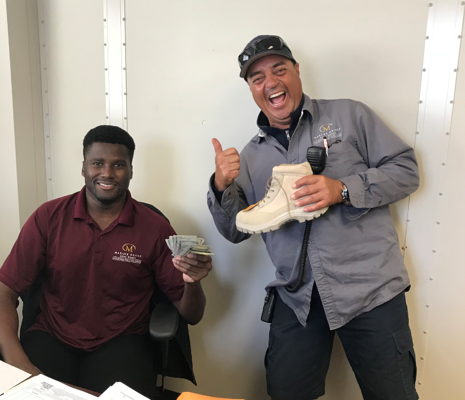 Travelift Operator Mario collecting his reimbursement from Darian!